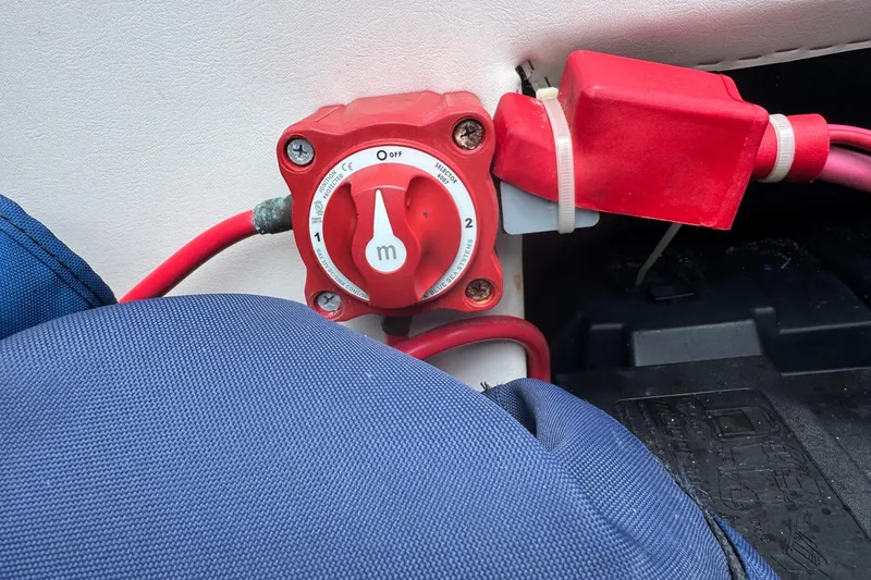Slide: The Image of Battery switch on a 2007 Bennington 2574 GL boat with red cables and blue cover. - 31