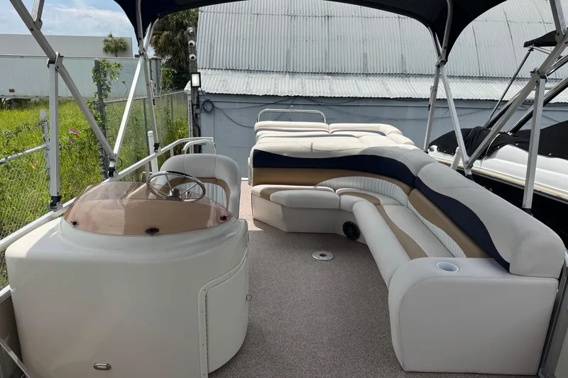 Slide: The Image of 2007 Bennington 2574 GL pontoon boat interior with plush seating and steering console. - 37