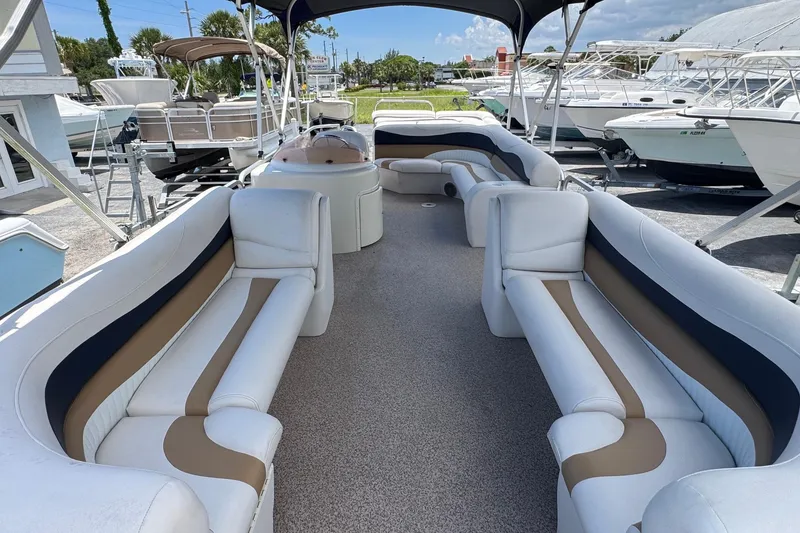 Slide: The Image of 2007 Bennington 2574 GL pontoon boat with spacious seating and canopy, docked outdoors. - 5