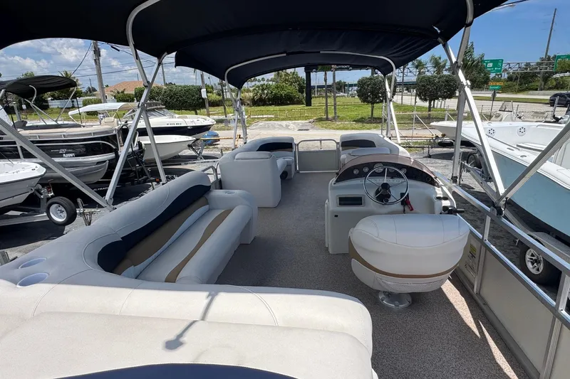 Slide: The Image of 2007 Bennington 2574 GL pontoon boat with spacious seating and canopy in a marina setting. - 6