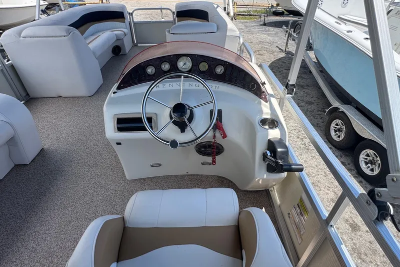 Slide: The Image of 2007 Bennington 2574 GL boat interior with steering wheel and seating area. - 7