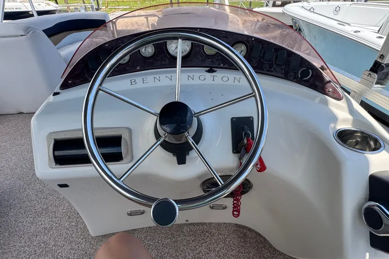 Slide: The Image of Steering wheel of a 2007 Bennington 2574 GL boat, showcasing dashboard controls. - 8