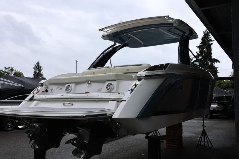 Slide: The Image of 2021 Cobalt R30 boat displayed in a showroom, rear view with open canopy. - 11