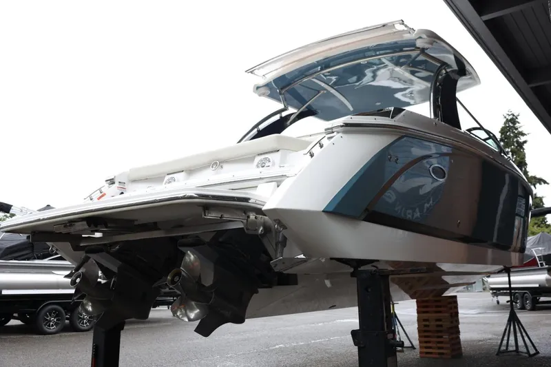 Slide: The Image of 2021 Cobalt R30 boat on lift, showcasing sleek design and dual propellers. - 14