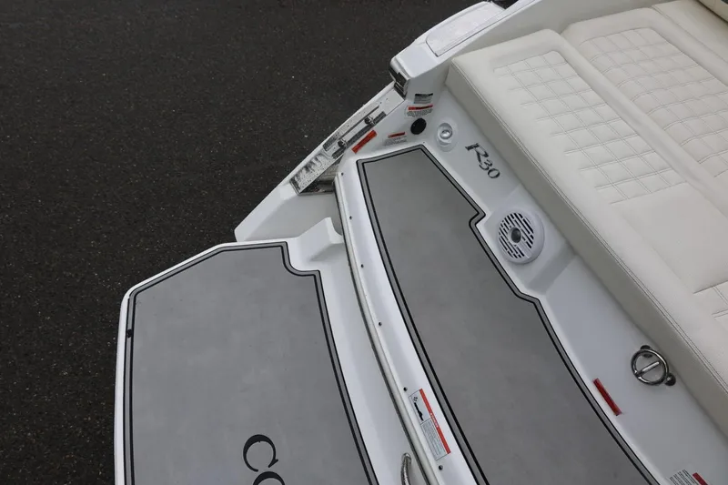 Slide: The Image of 2021 Cobalt R30 boat interior with cushioned seating and sleek design. - 26