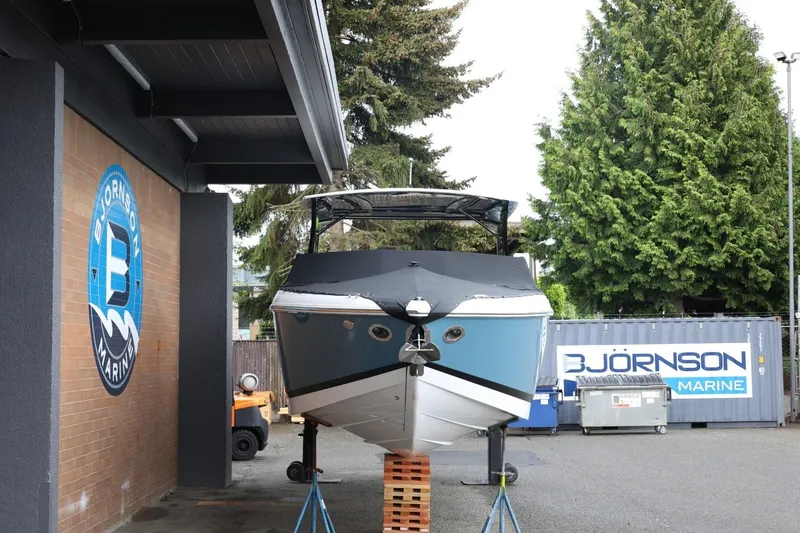 Slide: The Image of 2021 Cobalt R30 boat at Bjornson Marine, displayed outdoors on stands. - 3