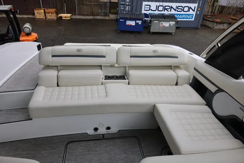 Slide: The Image of Luxurious seating area on a 2021 Cobalt R30 boat, featuring white cushioned upholstery. - 31