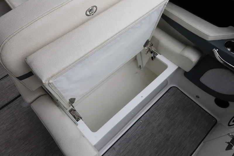 Slide: The Image of Open storage compartment on a 2021 Cobalt R30 boat with cushioned seating. - 35