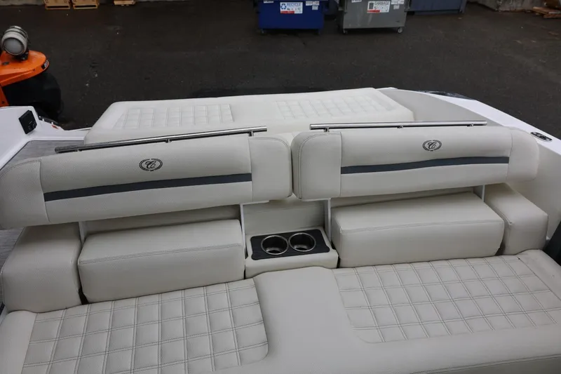 Slide: The Image of 2021 Cobalt R30 boat interior with luxurious white seating and cup holders. - 39