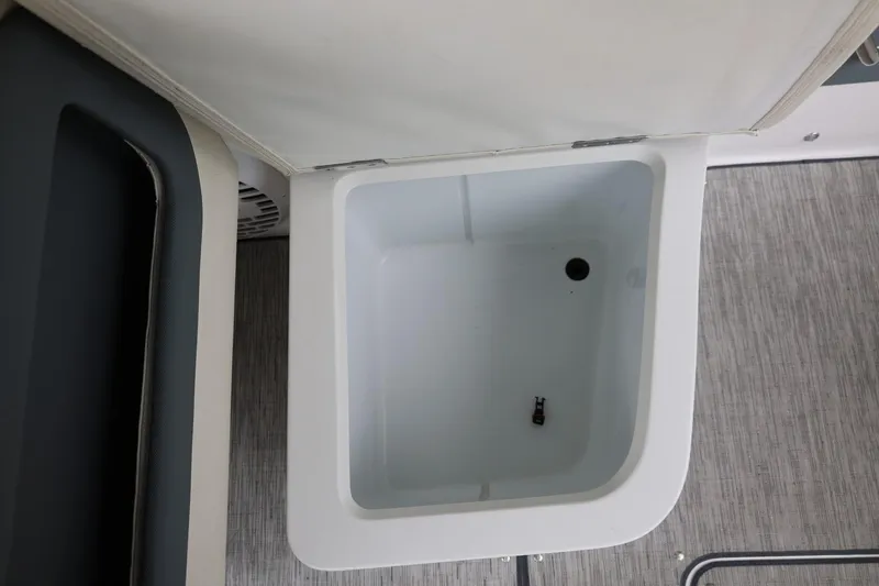 Slide: The Image of Storage compartment in 2021 Cobalt R30 boat, featuring a clean, white interior. - 41