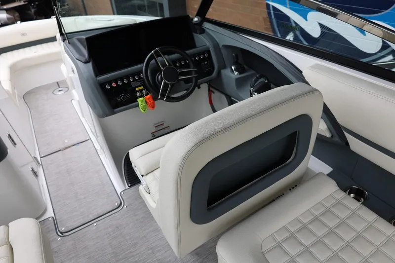 Slide: The Image of Interior view of a 2021 Cobalt R30 boat cockpit with modern steering and seating. - 42