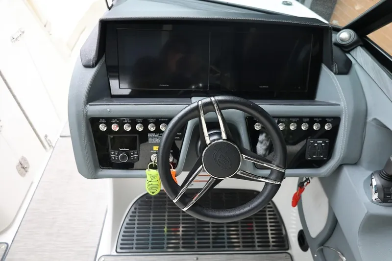 Slide: The Image of 2021 Cobalt R30 boat dashboard with steering wheel and control panel. - 43