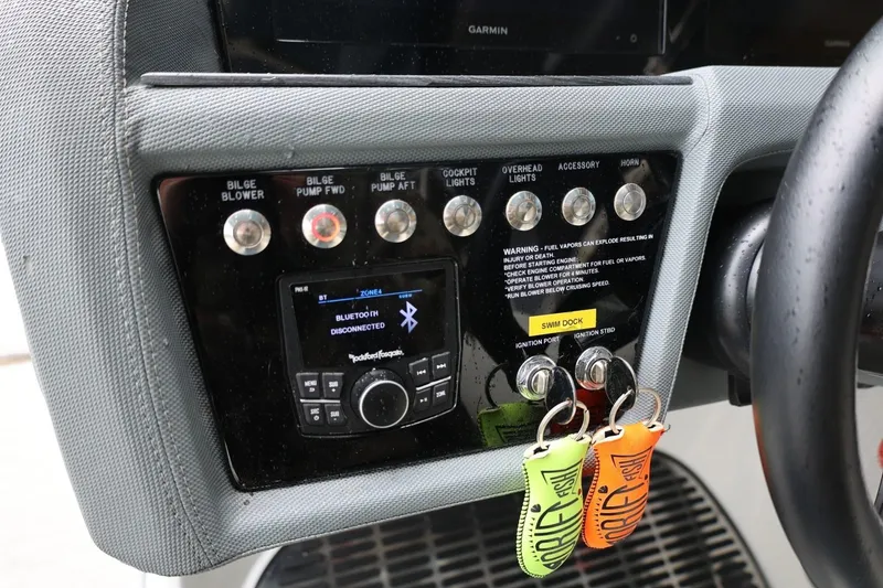 Slide: The Image of Control panel of a 2021 Cobalt R30 boat with Bluetooth and ignition keys. - 44