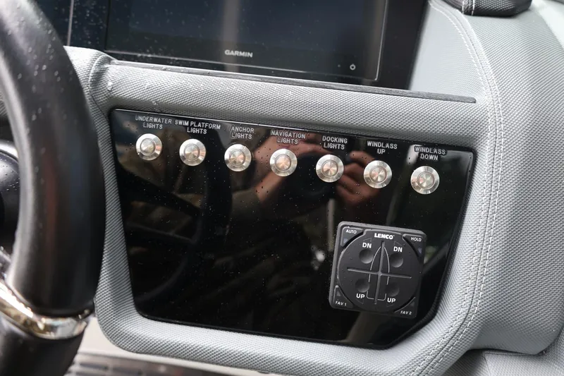 Slide: The Image of Control panel of a 2021 Cobalt R30 boat with various light switches and controls. - 45