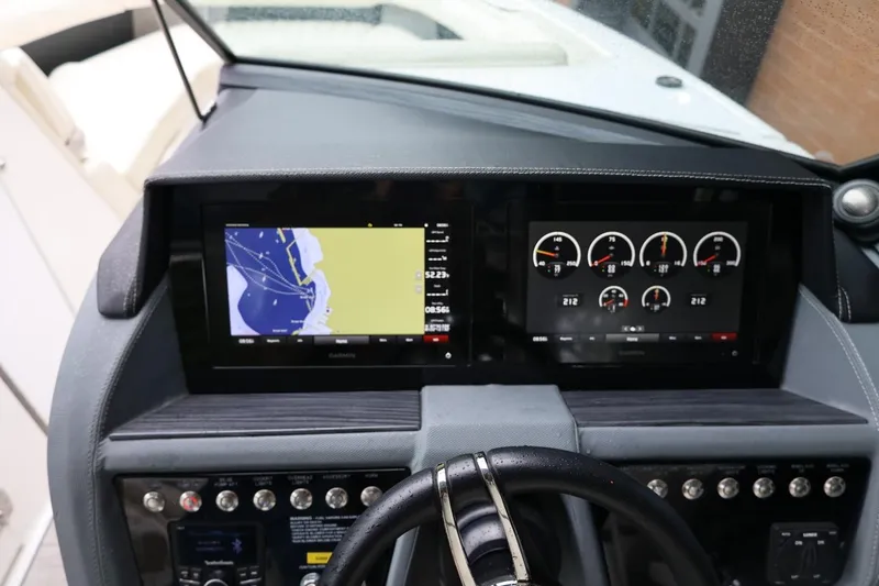 Slide: The Image of Dashboard of a 2021 Cobalt R30 boat featuring navigation and control displays. - 52