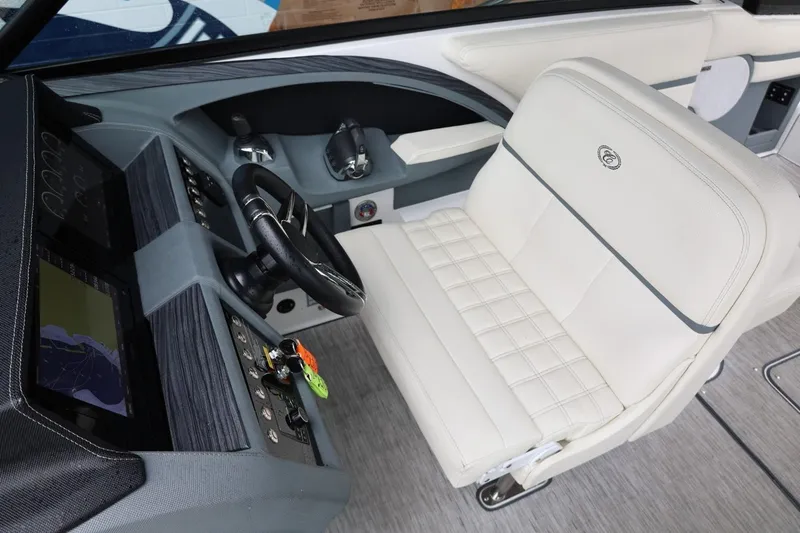 Slide: The Image of Interior of 2021 Cobalt R30 boat featuring a sleek dashboard and luxurious white seating. - 53