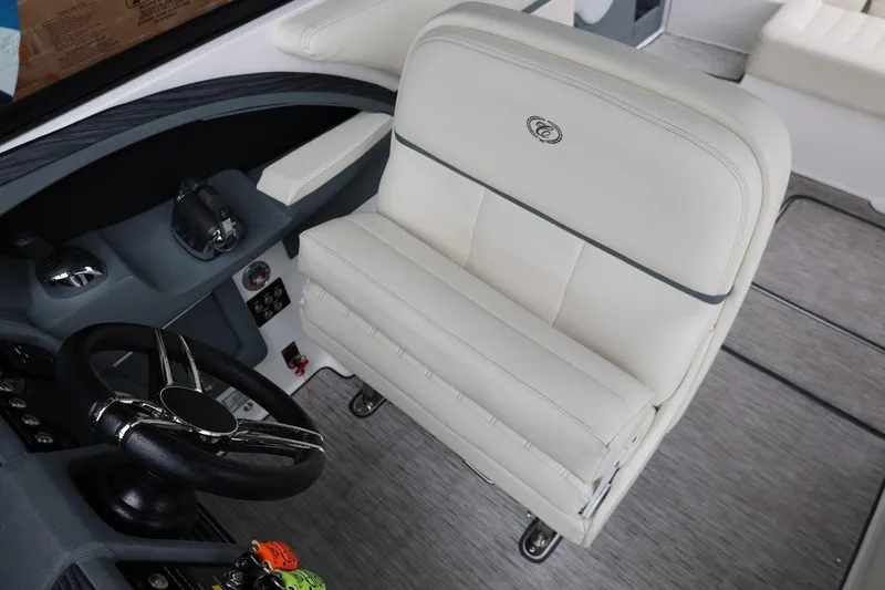 Slide: The Image of Captain's seat and helm of 2021 Cobalt R30 boat, featuring sleek design and controls. - 54