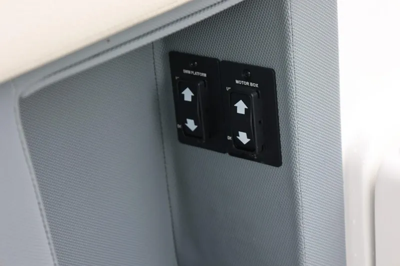 Slide: The Image of Control panel on a 2021 Cobalt R30 boat with up and down switches. - 55