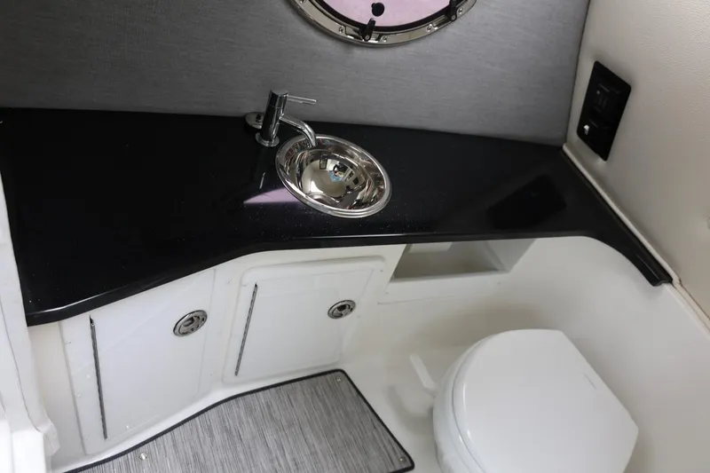 Slide: The Image of 2021 Cobalt R30 boat bathroom with sleek black countertop and compact design. - 61