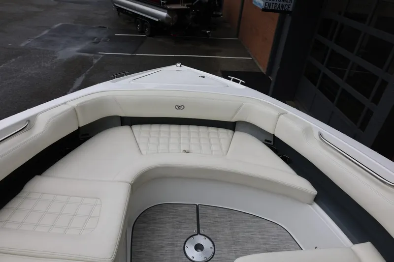 Slide: The Image of 2021 Cobalt R30 boat interior with white cushioned seating and sleek design. - 69