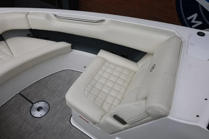 Slide: The Image of 2021 Cobalt R30 boat interior with white cushioned seating. - 70