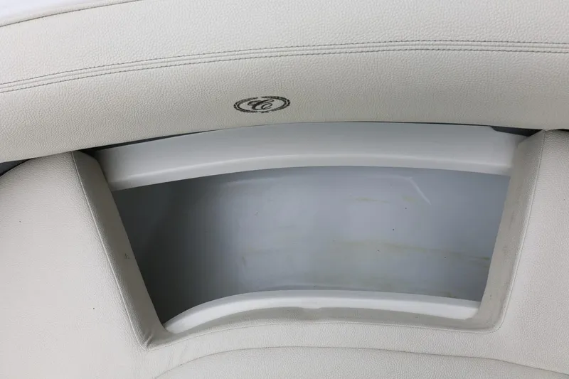 Slide: The Image of 2021 Cobalt R30 boat storage compartment with white cushioned seating. - 72