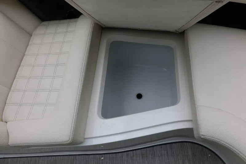 Slide: The Image of Storage compartment in 2021 Cobalt R30 boat with cushioned seating. - 74