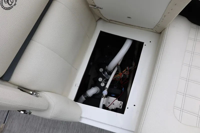 Slide: The Image of Open compartment in 2021 Cobalt R30 boat seat showing internal wiring and components. - 75