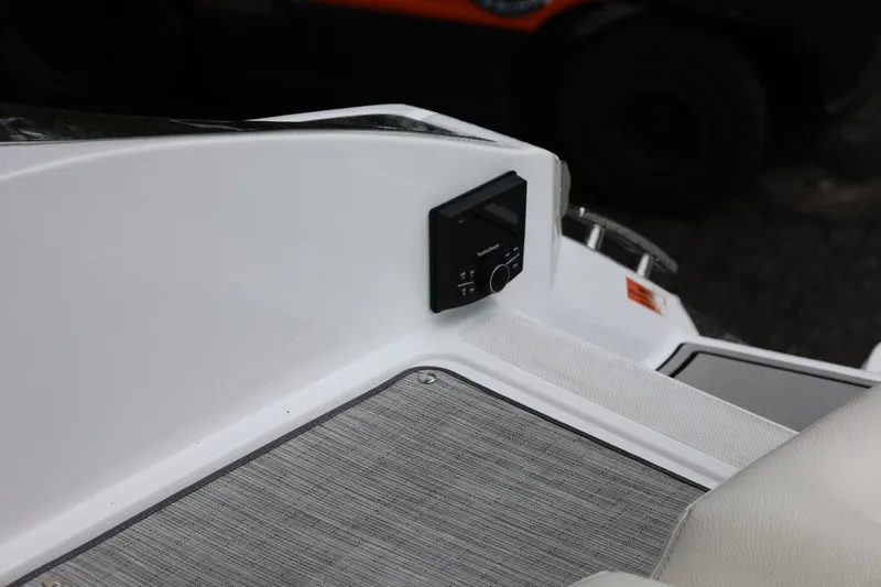 Slide: The Image of 2021 Cobalt R30 boat interior with audio control panel and textured flooring. - 78