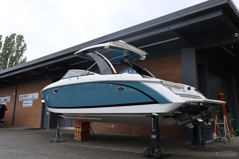 Slide: The Image of 2021 Cobalt R30 boat elevated for maintenance outside a building. - 8