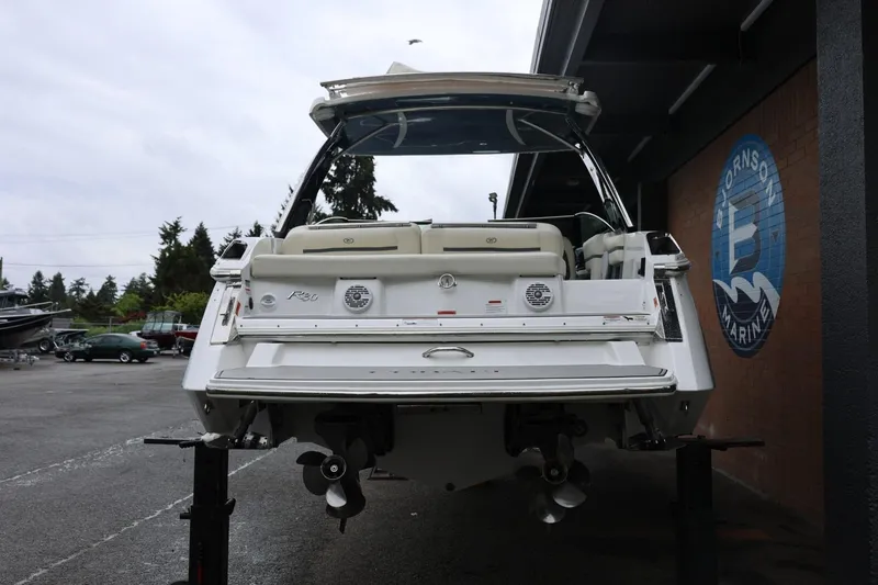 Slide: The Image of 2021 Cobalt R30 boat displayed at a marina, rear view with dual propellers. - 9