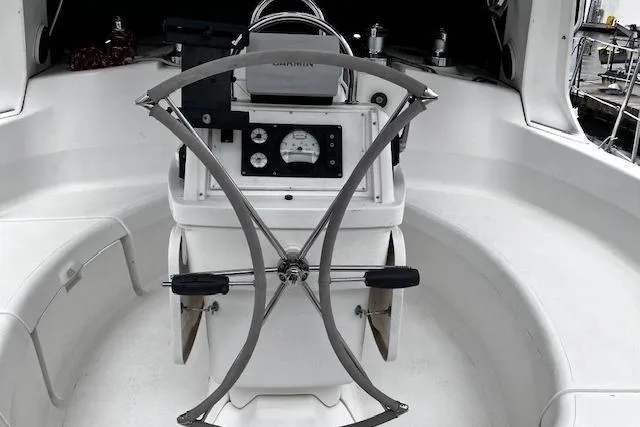 Slide: The Image of Cockpit of a 1996 Hunter 430 sailboat with steering wheel and navigation instruments. - 10