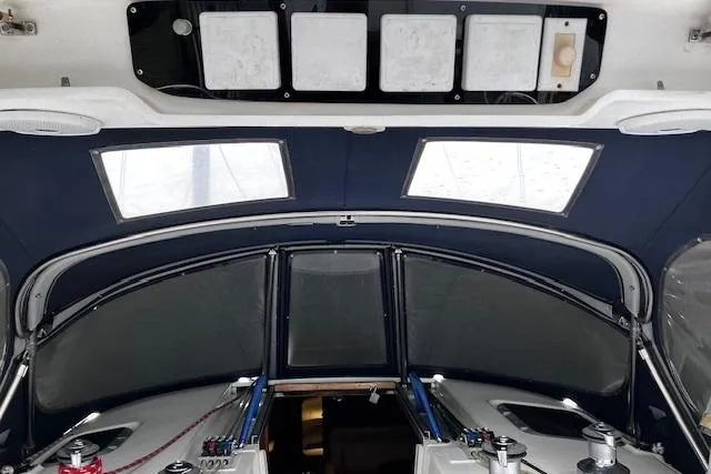 Slide: The Image of Interior view of a 1996 Hunter 430 sailboat cockpit with blue canopy and control panels. - 12