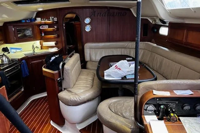 Slide: The Image of Interior of a 1996 Hunter 430 sailboat with cozy seating and wooden finishes. - 2