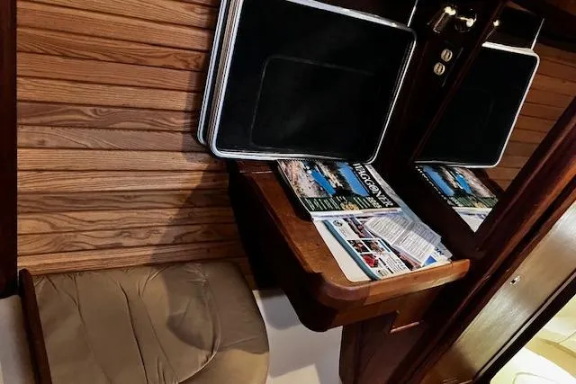 Slide: The Image of Interior of a 1996 Hunter 430 sailboat with wooden paneling and a cozy seating area. - 4