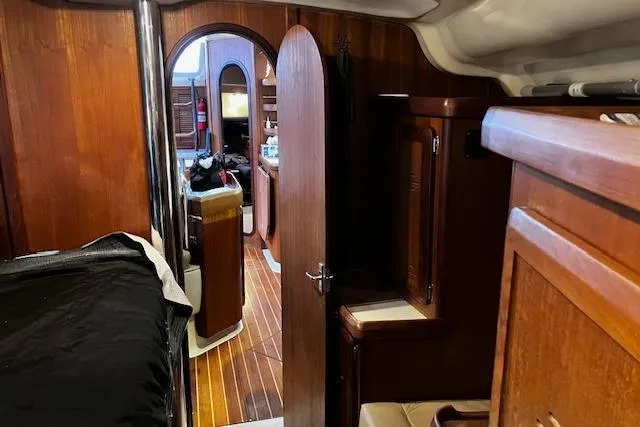 Slide: The Image of Interior of a 1996 Hunter 430 sailboat with wooden furnishings and cozy cabin space. - 7