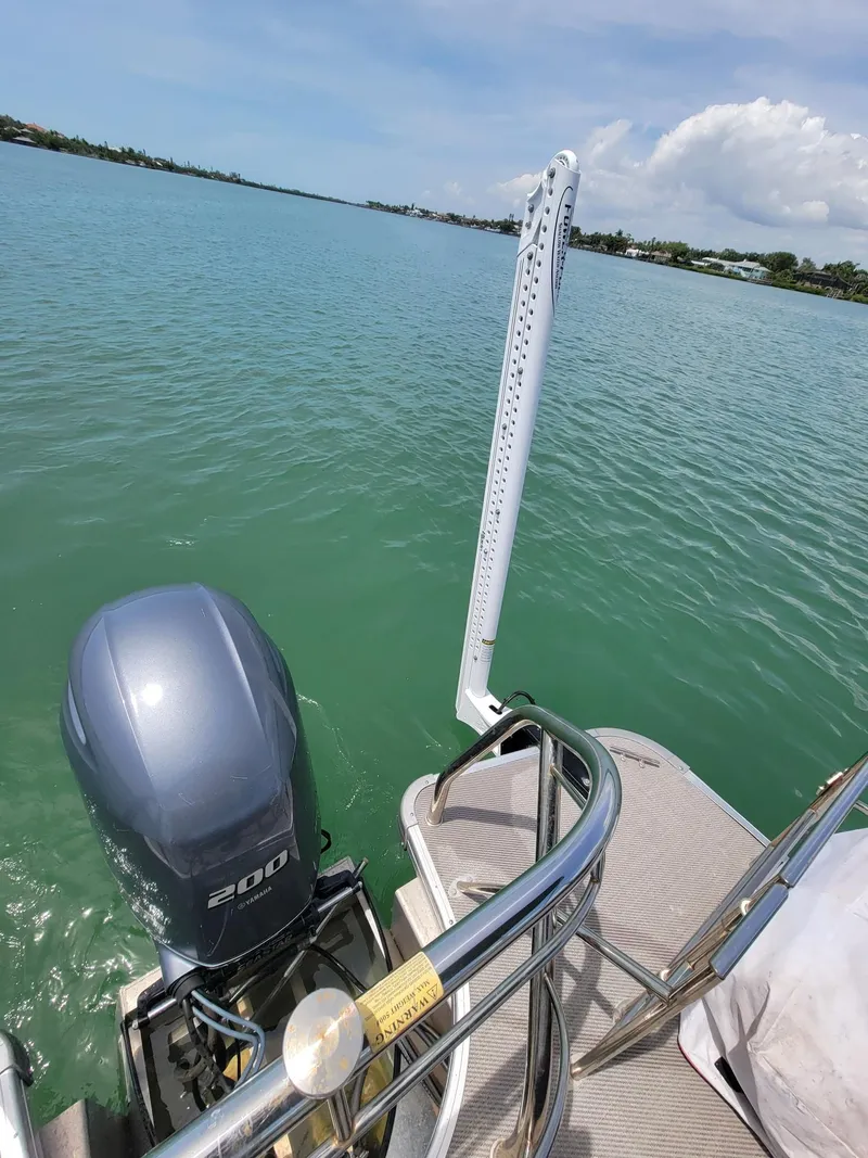 Slide: The Image of GODFREY MARINE Monaco 2021 boat on calm water with outboard motor. - 10