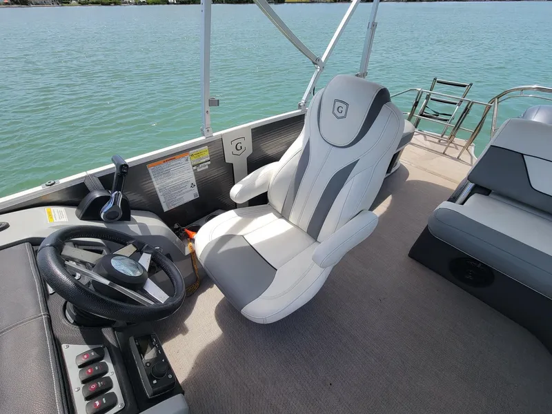 Slide: The Image of Interior of a 2021 Godfrey Marine Monaco boat with helm station. - 3