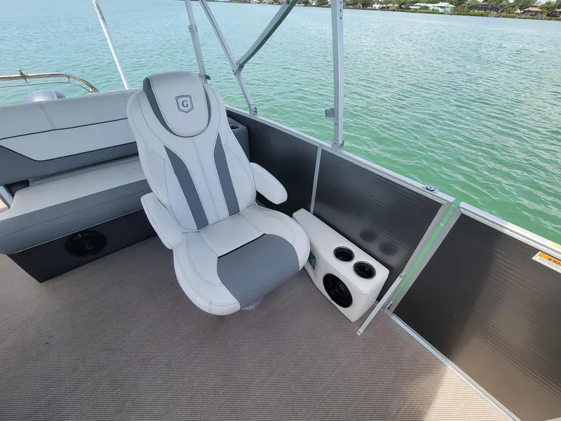 Slide: The Image of 2021 Godfrey Marine Monaco boat with luxurious seating by the water. - 4
