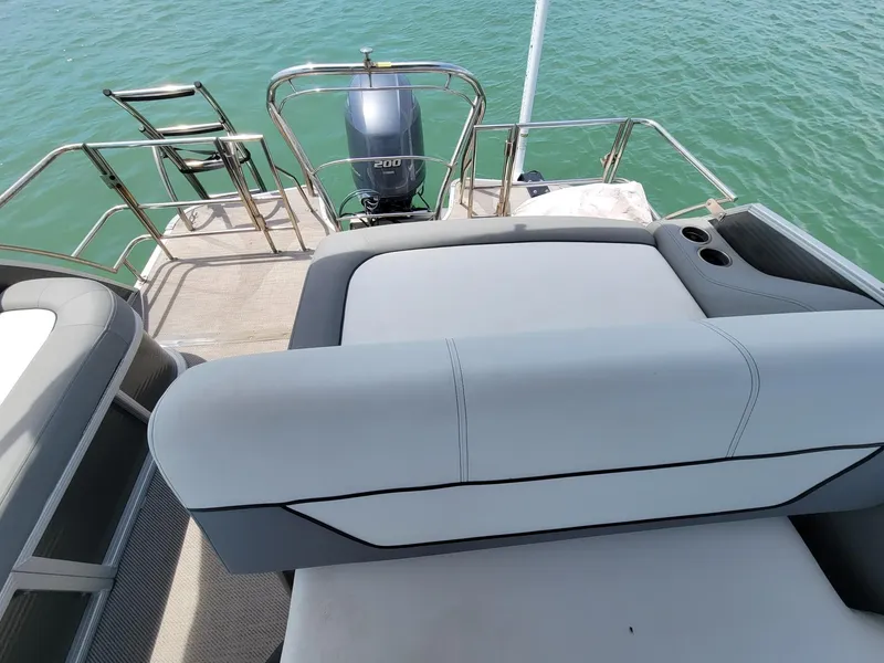 Slide: The Image of 2021 Godfrey Marine Monaco boat with outboard motor on calm water. - 8