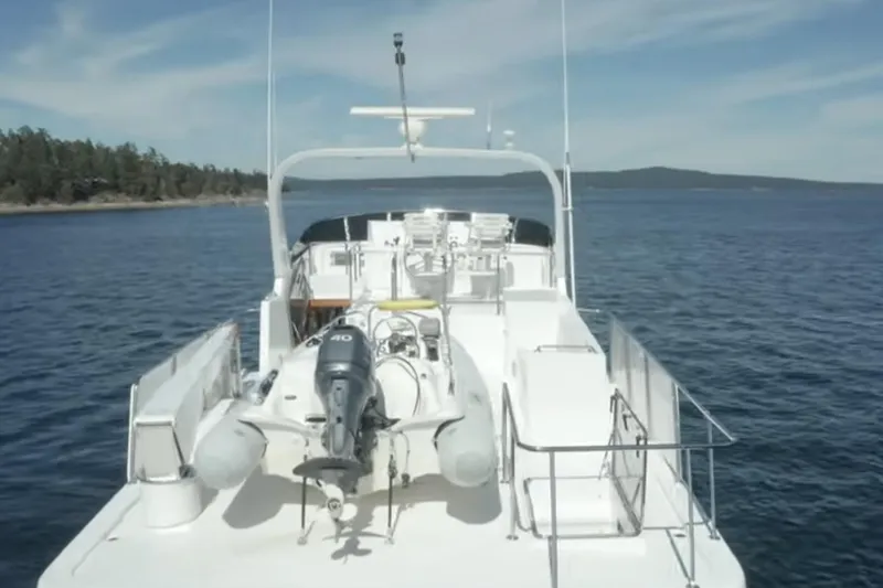 Slide: The Image of 2003 Jefferson Pilothouse 53 yacht on calm waters with scenic island backdrop. - 14