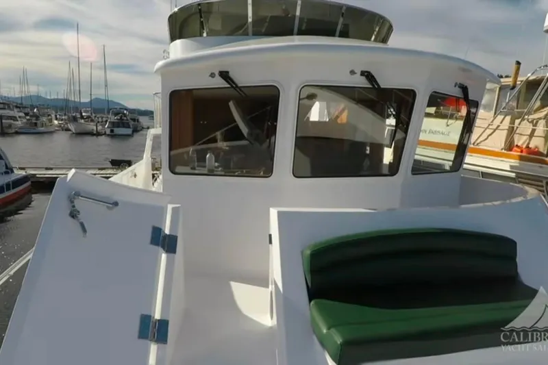Slide: The Image of 2003 Jefferson Pilothouse 53 yacht docked at marina, featuring sleek design and spacious deck. - 15
