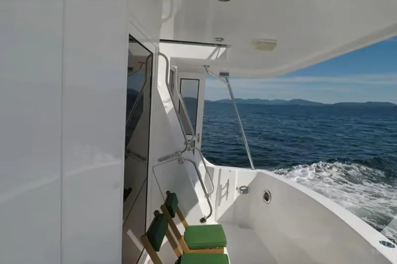 Slide: The Image of 2003 Jefferson Pilothouse 53 yacht cruising on open water with scenic ocean view. - 16