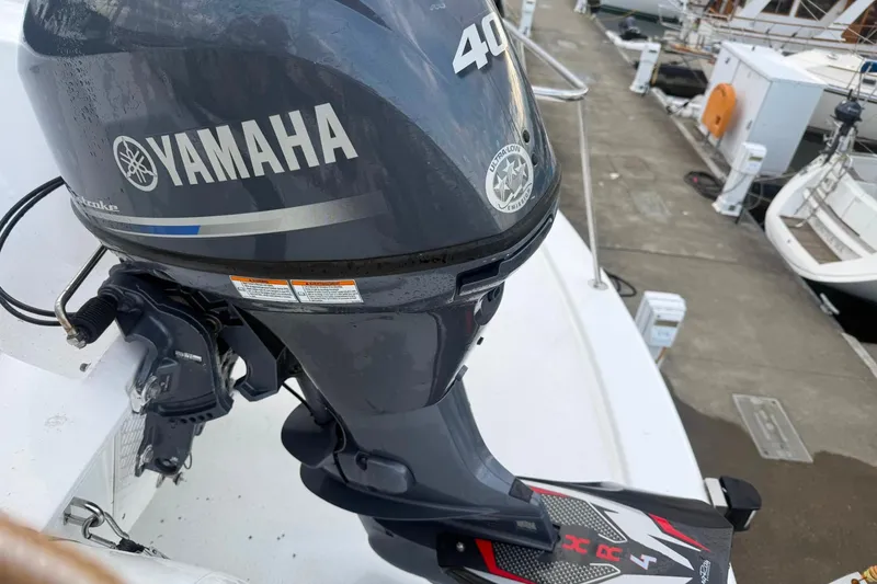 Slide: The Image of Yamaha 40HP outboard motor on a 2003 Jefferson Pilothouse 53 boat at a marina. - 19
