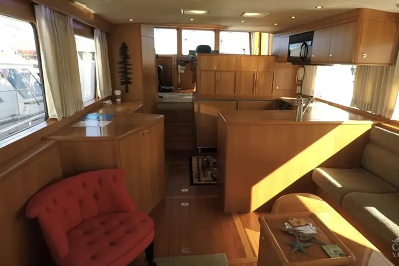Slide: The Image of Interior of 2003 Jefferson Pilothouse 53 yacht with wood cabinetry and seating area. - 5