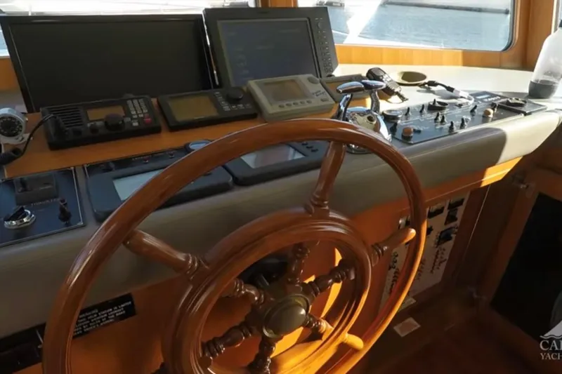 Slide: The Image of Pilothouse of 2003 Jefferson Pilothouse 53 yacht with wooden steering wheel and navigation equipment. - 8