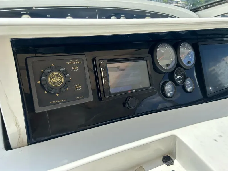 Slide: The Image of Dashboard of a 1999 Pershing 54 yacht with navigation controls and gauges. - 3