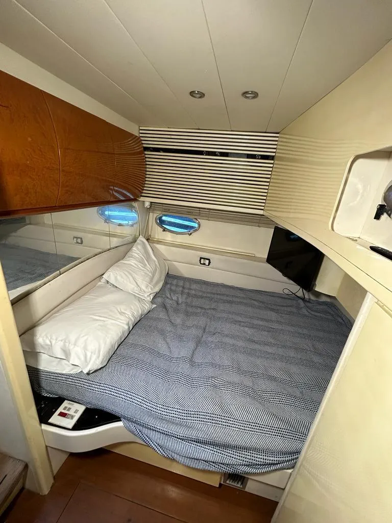 Slide: The Image of Cozy bedroom cabin in a 1999 Pershing 54 yacht with modern amenities. - 32