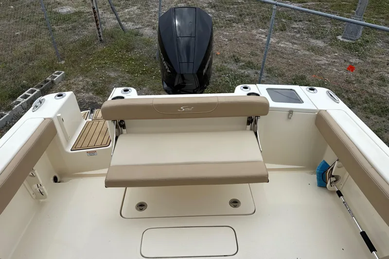 Slide: The Image of 2023 Scout 215 Dorado boat interior with seating and outboard motor. - 11