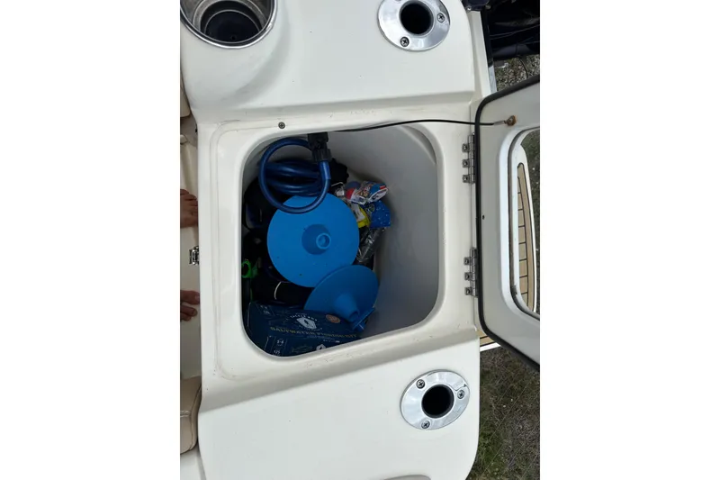 Slide: The Image of Storage compartment of 2023 Scout 215 Dorado boat with various boating accessories. - 13